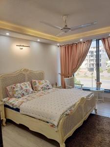 a bedroom with a bed and a large window at Holiday Inn islamabad in Islamabad