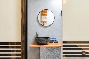 WangcunにあるFloral Hotel Furong Town Qichi Innの洗面台と鏡のあるバスルーム