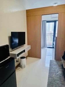 a living room with a flat screen tv on a counter at City Escape in Manila