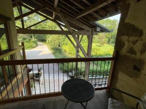 a balcony with a table and a view at ChezLeMoulin Bed and Breakfast in Samouillan