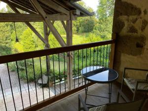 a balcony with a table and chairs on a porch at ChezLeMoulin Bed and Breakfast in Samouillan +39 photos