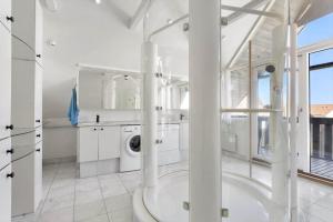 a large white bathroom with a washer and dryer at LK2169-Lokken-Sondergade-25-A in Løkken +28 photos