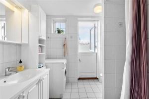 a white bathroom with a sink and a shower at 1278-N-Liseleje-Kystvej-12 in Liseleje +22 photos