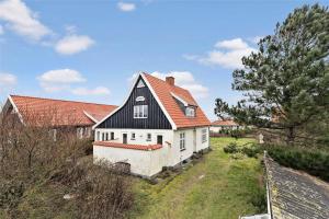 a small white house with an orange roof at 1278-N-Liseleje-Kystvej-12 in Liseleje