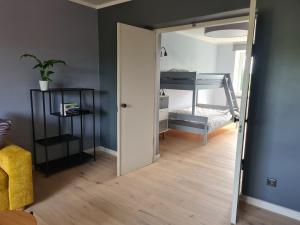 a room with a bunk bed and a room with a mirror at Spacious and quiet 2BR apartment in Tartu