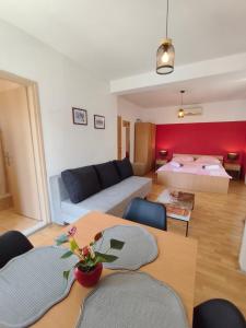 a living room with a couch and a bed at Apartments Lans in Vodice