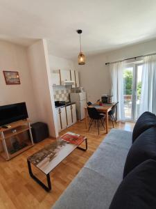 a living room with a couch and a table at Apartments Lans in Vodice