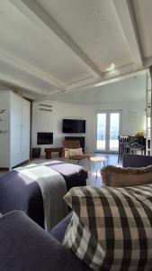 a room with two beds and a living room at For a couple - beautiful sea view in Postira