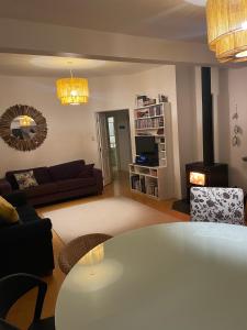 a living room with a table and a couch at Gone Coastal - Whangamata Holiday House in Whangamata
