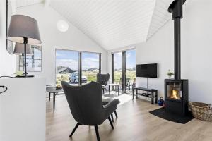a living room with a chair and a fireplace at LK1240-Lokken-Rosavej-13 in Løkken