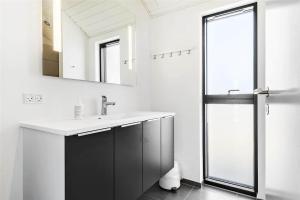 a bathroom with a sink and a mirror at LK1240-Lokken-Rosavej-13 in Løkken +26 photos