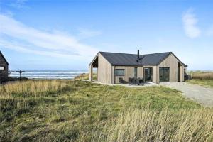 a house on a hill with the ocean in the background at LK1240-Lokken-Rosavej-13 in Løkken
