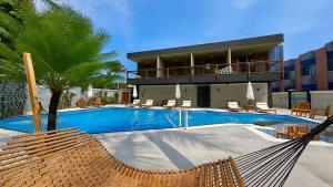 a resort with a swimming pool and a building at Marmeu Tropical in Guarujá +14 photos