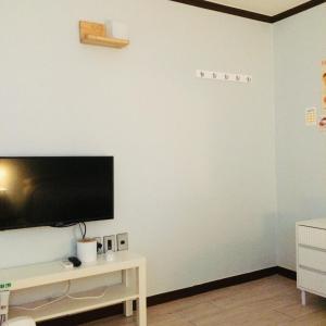 a living room with a flat screen tv on a wall at Cozy Butter Stay Jeonju in Jeonju