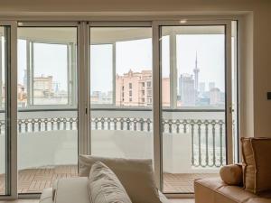 a living room with a couch and views of a city at Yu Garden Riverside Retreat 3BR with Latex Mattresses in Shanghai