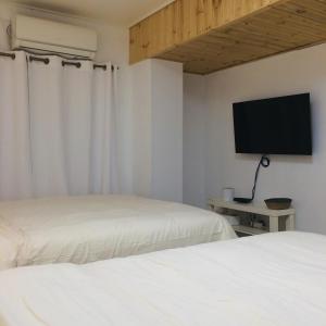 a bedroom with two beds and a flat screen tv at Cozy Butter Stay Jeonju in Jeonju +70 photos