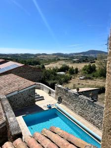 a swimming pool on the side of a house at Gite du Chateau in Éclassan +8 photos