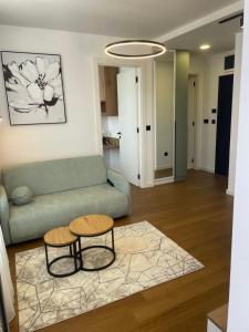 a living room with a couch and a table at Apartman Tri vrha Spa & Wellness Zlatibor in Zlatibor