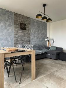 a living room with a couch and a table at Le coin des voyageurs in Chalon-sur-Saône +17 photos