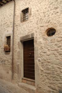 a stone building with a door and two windows at Il Paradiso nel Borgo in Arrone