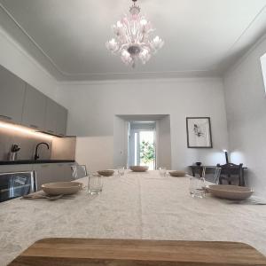 a large kitchen with a chandelier in a room at Carpegna Green House in Carpegna