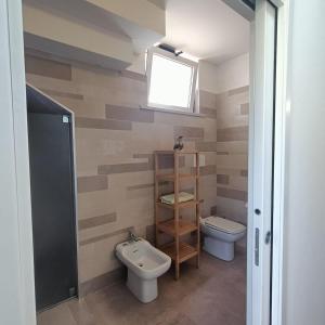 a bathroom with a toilet and a sink at Carpegna Green House in Carpegna +24 photos