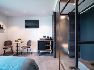 a bedroom with a desk and a table with chairs at Afslag 5 Texel Bed by Brandenburg in Den Burg