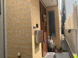 a building with a brick wall with a door at 5LDK3toilets: 最近の駅6分・スカイツリー電車1分・浅草電車4分・NRT電車60分 in Tokyo