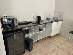 a kitchen with a counter top with a microwave at Sophia’s Cottage in Cape Town