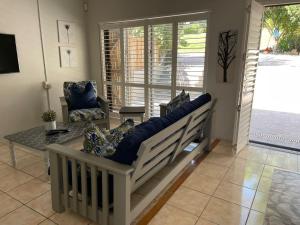 a living room with a couch and a chair at Sophia’s Cottage in Cape Town