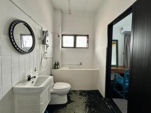 a bathroom with a toilet and a tub and a sink at Cozy Homestay SS2 PJ King Bed in Shared Bungalow in Petaling Jaya +15 photos