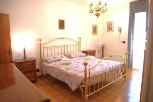 a bedroom with a bed and a dresser in it at Iolanda Apartment in Chiusi