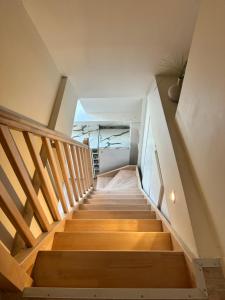 a staircase in a house with wooden floors at Appartement Duplex -Vue sur mer- à 100 m de la plage in Le Portel