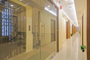 a hallway with a glass shower in a building at Super Townhouse Centre Point Inn Near Esplanade Metro Station in Kolkata +37 photos