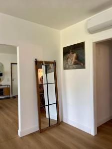 a room with a mirror and a painting on the wall at Vico Suite in Santa Maria a Vico