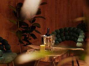 a table with a bottle of wine and a candle at Bohinj River House Spa&Sport in Bohinj