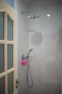a shower with a shower head in a bathroom at Apartment on Takaishvili in Batumi