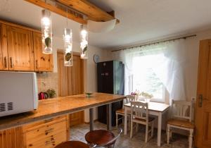 a kitchen with a counter and a table with chairs at ``Art home Baroni`` in Cēsis