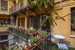 a balcony with potted plants on a building at Heritage Four Suites in Milan