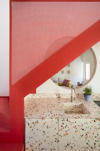 a room with a staircase and a red stair case at NEST LIVING - Red Velvet in Udine