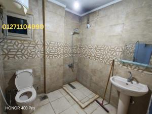 a bathroom with a toilet and a sink at شقة في كمباوند النورس علي البحر in Ismailia