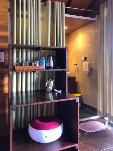 a room with a counter with a red stool under it at Barn Hills in Ella