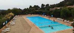 an overhead view of a large swimming pool with people in it at Bella Vista Colline Valmer in La Croix-Valmer +1 photo