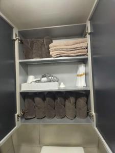 a closet with a bunch of towels and towels at Shinhwahouse 5 mins from Seoul Station in Seoul