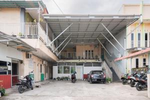 a group of motorcycles parked in front of a building at Urbanview Hotel Mine Residence Syariah in Padang
