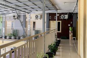 a hallway with potted plants in a building at Urbanview Hotel Mine Residence Syariah in Padang