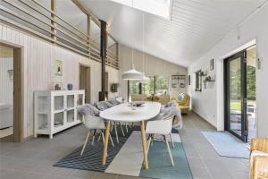 a dining room with a white table and chairs at LK1443-Lokken-Oddervej-5-a in Løkken