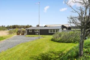 a house with a gravel driveway in front of it at LK1802-Lokken-Septembervej-2-b in Løkken