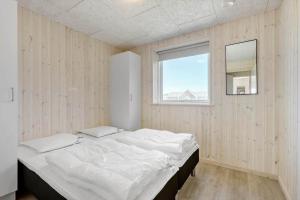 a large bed in a room with a window at LK1886-Lokken-Kallehaven-3 in Løkken +31 photos