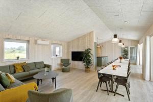 a living room with a couch and a table at LK1886-Lokken-Kallehaven-3 in Løkken